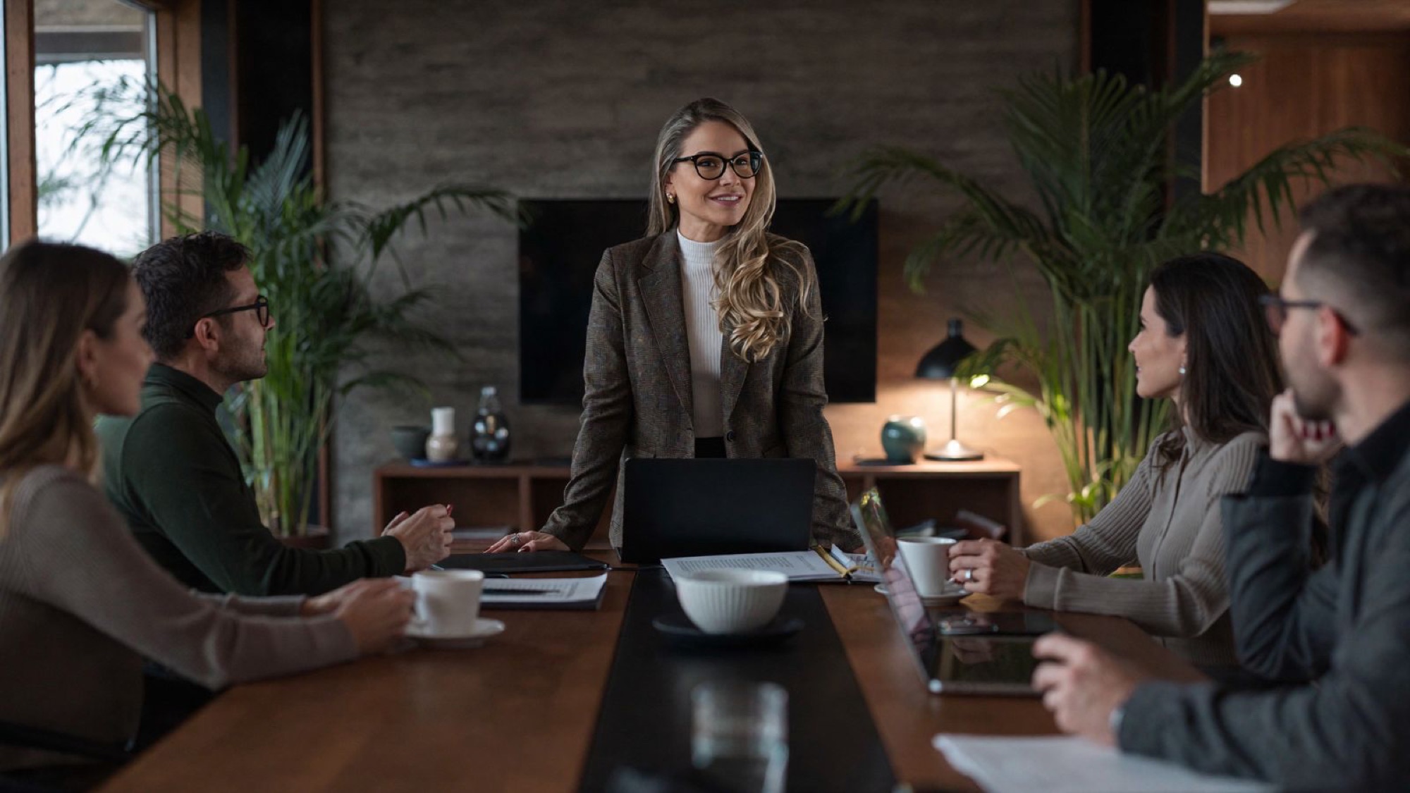 Betina Weber leading a strategy meeting at the head of a table